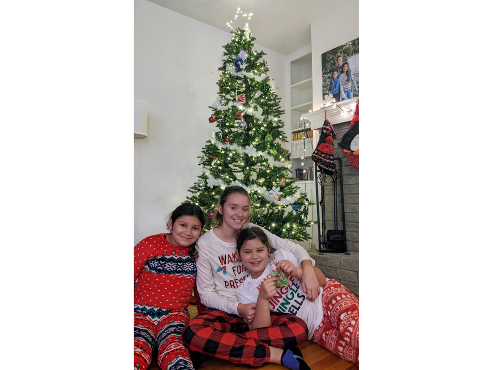 The girls in their PJs in front of our tree.