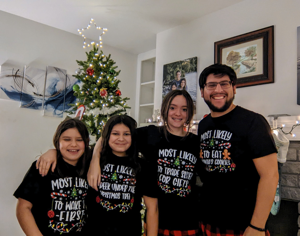 Us in matching PJs in front of our tree.