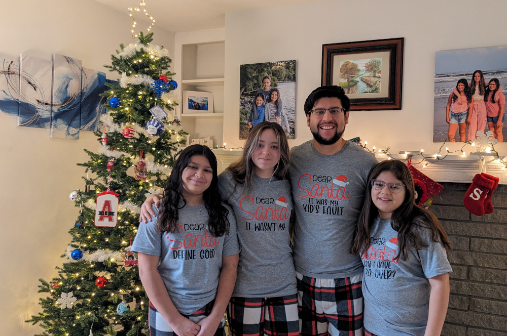 Us in matching PJs in front of our tree.